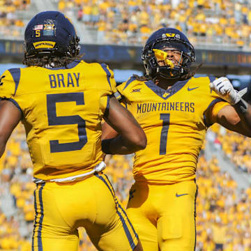 Aug 30, 2025; Morgantown, West Virginia, USA; West Virginia Mountaineers running back Jahiem White (1) scores a touchdown and celebrates with West Virginia Mountaineers wide receiver Jaden Bray (5) during the third quarter at Milan Puskar Stadium. Mandatory Credit: Ben Queen-Imagn Images