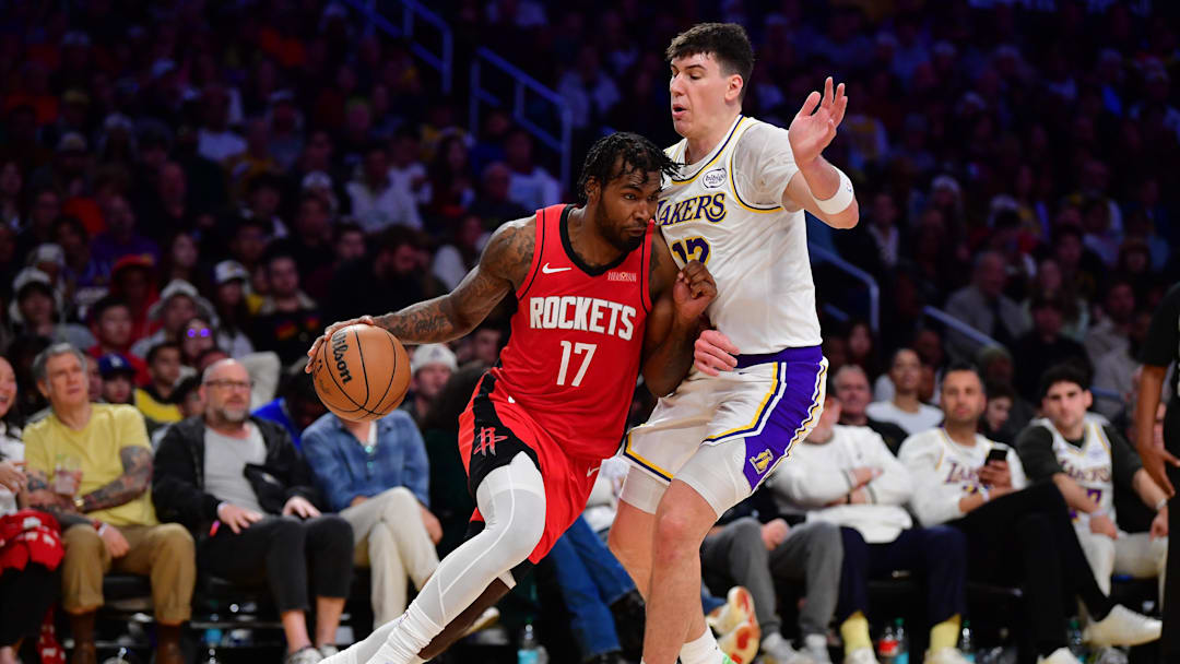 Dec 25, 2025; Los Angeles, California, USA; Houston Rockets forward Tari Eason (17) moves the ball against Los Angeles Lakers forward Jake LaRavia (12) during the second half at Crypto.com Arena. Mandatory Credit: Gary A. Vasquez-Imagn Images