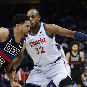 Mar 13, 2025; Detroit, Michigan, USA;  Detroit Pistons forward Tobias Harris (12) dribbles defended by Washington Wizards forward Khris Middleton (32) in the second half at Little Caesars Arena. Mandatory Credit: Rick Osentoski-Imagn Images