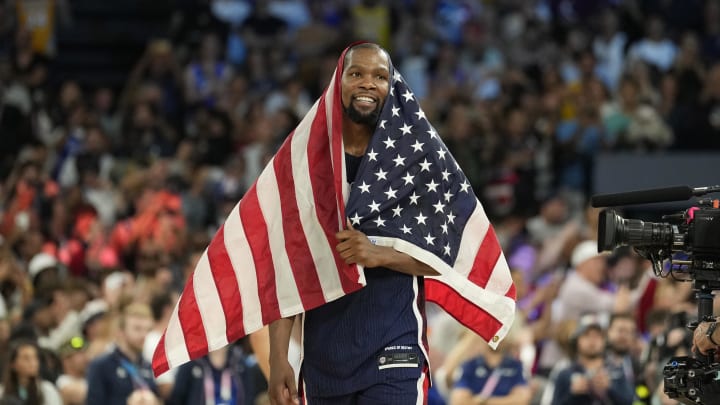 Aug 10, 2024; Paris, France; United States guard Kevin Durant (7) celebrates after defeating France in the men's basketball gold medal game during the Paris 2024 Olympic Summer Games at Accor Arena. Mandatory Credit: Kyle Terada-USA TODAY Sports