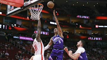 Oct 8, 2025; Houston, Texas, USA; Utah Jazz forward Cody Williams (5) shoots the ball as Houston Rockets center Clint Capela (30) defends during the second quarter at Toyota Center. Mandatory Credit: Troy Taormina-Imagn Images