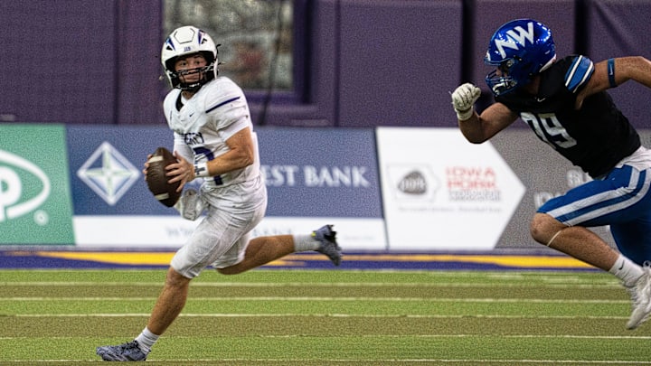 Iowa City Liberty's Reece Rettig looks to attempt a pass as Waukee Northwest's Jackson Davis brings pressure during the semifinal round of the Iowa high school football state championships at the UNI-Dome on Friday, Nov. 14, 2025, in Cedar Falls.