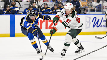 Nov 19, 2024; St. Louis, Missouri, USA;  Minnesota Wild left wing Kirill Kaprizov (97) shoots as St. Louis Blues left wing Pavel Buchnevich (89) defends during the third period at Enterprise Center. Mandatory Credit: Jeff Curry-Imagn Images