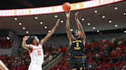 Mar 2, 2023; Houston, Texas, USA; Wichita State Shockers guard Jaron Pierre Jr. (5) shoots the ball over Houston Cougars guard Tramon Mark (12) during the first half at Fertitta Center. Mandatory Credit: Troy Taormina-Imagn Images