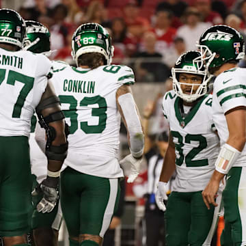 Sep 9, 2024; Santa Clara, California, USA; New York Jets guard John Simpson (76), New York Jets offensive tackle Tyron Smith (77), New York Jets tight end Tyler Conklin (83), New York Jets wide receiver Xavier Gipson (82), New York Jets quarterback Aaron Rodgers (8), and New York Jets running back Breece Hall (20) in the huddle against the San Francisco 49ers in the fourth quarter at Levi's Stadium. 