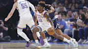 Oct 17, 2025; Oklahoma City, Oklahoma, USA; Oklahoma City Thunder guard Cason Wallace (22) moves past Denver Nuggets forward Cameron Johnson (23) during the first half at Paycom Center.