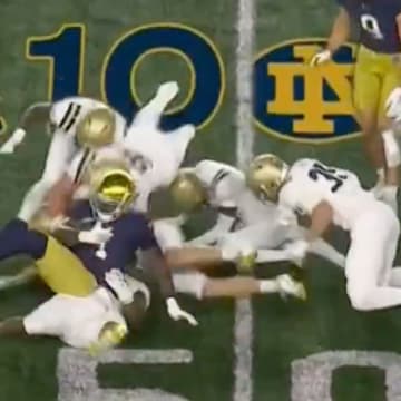 Love (#4) was swarmed by Navy defenders but somehow still managed to score a touchdown on this play. 