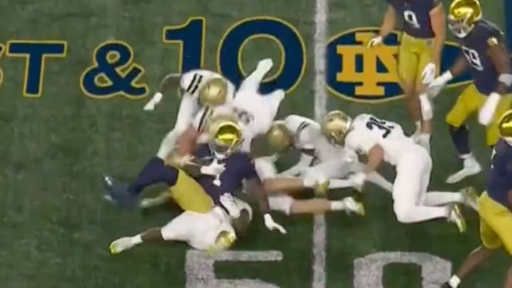 Love (#4) was swarmed by Navy defenders but somehow still managed to score a touchdown on this play. 