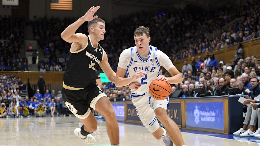Nov 16, 2024; Durham, North Carolina, USA;  Duke Blue Devils guard Cooper Flagg (2) drives the ball down the baseline against Wofford Terriers forward Jeremy Lorenz (32) during the second half at Cameron Indoor Stadium. Mandatory Credit: Zachary Taft-Imagn Images
