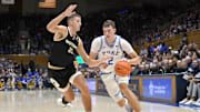 Nov 16, 2024; Durham, North Carolina, USA;  Duke Blue Devils guard Cooper Flagg (2) drives the ball down the baseline against Wofford Terriers forward Jeremy Lorenz (32) during the second half at Cameron Indoor Stadium. Mandatory Credit: Zachary Taft-Imagn Images