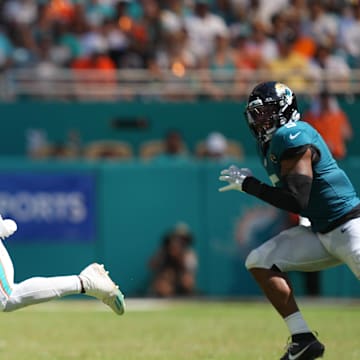 Sep 8, 2024; Miami Gardens, Florida, USA;  Miami Dolphins wide receiver Tyreek Hill (10) catches a pass for an 80-yard touchdown in the third quarter as Jacksonville Jaguars safety Andre Cisco (5) follows on the play at Hard Rock Stadium.