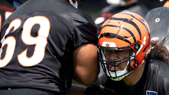 Cincinnati Bengals defensive tackle B.J. Hill (92) hits Cincinnati Bengals defensive tackle Devonnsha Maxwell (69) at the Bengals NFL practice in Cincinnati on Tuesday, June 4, 2024.