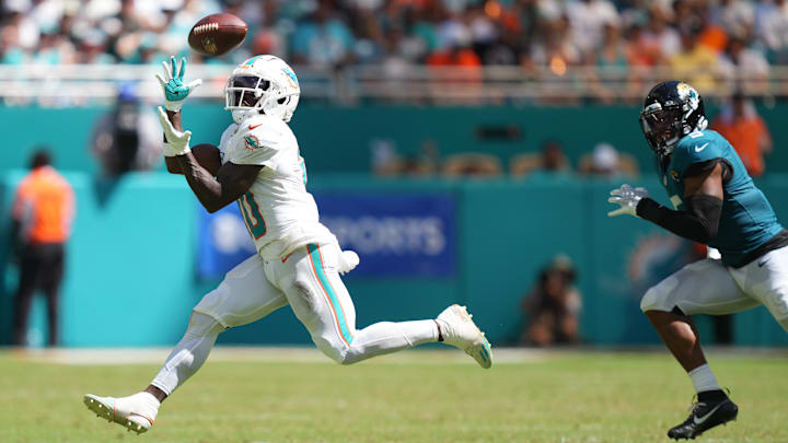 Miami Dolphins wide receiver Tyreek Hill (10) catches a pass for an 80-yard touchdown in the third quarter as Jacksonville Jaguars safety Andre Cisco (5) follows on the play at Hard Rock Stadium.