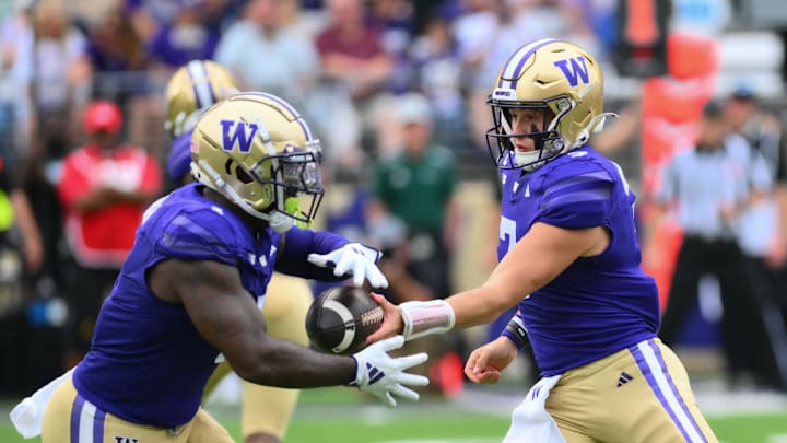 Sep 7, 2024; Seattle, Washington, USA; Washington Huskies quarterback Will Rogers (7) hands the ball off to running back Jonah Coleman (1) during the first half against the Eastern Michigan Eagles at Alaska Airlines Field at Husky Stadium. Mandatory Credit: Steven Bisig-Imagn Images