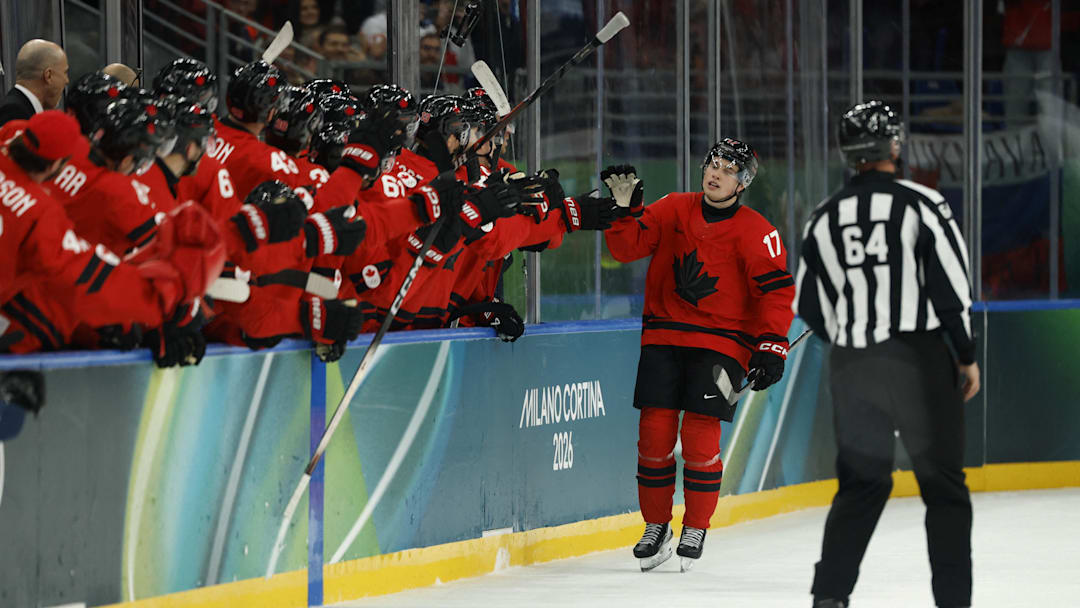 Feb 15, 2026; Milan, Italy; Macklin Celebrini of Canada celebrates scoring their fifth goal with teammates  against France  in men's ice hockey group A play during the Milano Cortina 2026 Olympic Winter Games at Milano Santagiulia Ice Hockey Arena. Mandatory Credit: Geoff Burke-Imagn Images