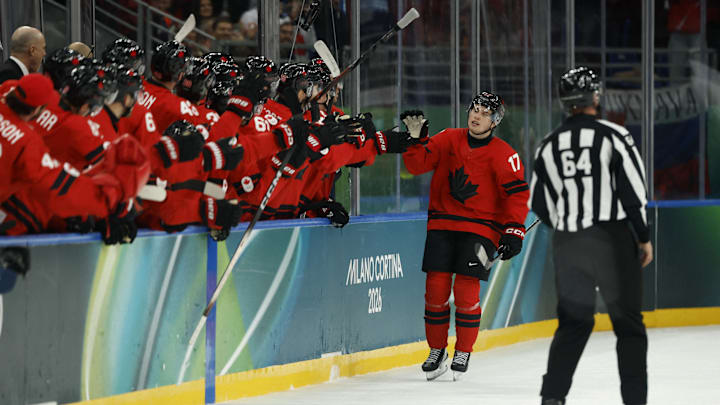 Feb 15, 2026; Milan, Italy; Macklin Celebrini of Canada celebrates scoring their fifth goal with teammates  against France  in men's ice hockey group A play during the Milano Cortina 2026 Olympic Winter Games at Milano Santagiulia Ice Hockey Arena. Mandatory Credit: Geoff Burke-Imagn Images