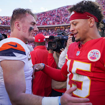 Nov 10, 2024; Kansas City, Missouri, USA; Denver Broncos quarterback Bo Nix (10) talks with Kansas City Chiefs quarterback Patrick Mahomes (15) after the game at GEHA Field at Arrowhead Stadium. 
