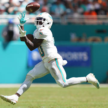 Sep 8, 2024; Miami Gardens, Florida, USA;  Miami Dolphins wide receiver Tyreek Hill (10) catches a pass for an 80-yard touchdown in the third quarter as Jacksonville Jaguars safety Andre Cisco (5) follows on the play at Hard Rock Stadium.