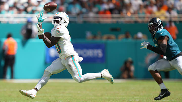 Sep 8, 2024; Miami Gardens, Florida, USA;  Miami Dolphins wide receiver Tyreek Hill (10) catches a pass for an 80-yard touchdown in the third quarter as Jacksonville Jaguars safety Andre Cisco (5) follows on the play at Hard Rock Stadium.