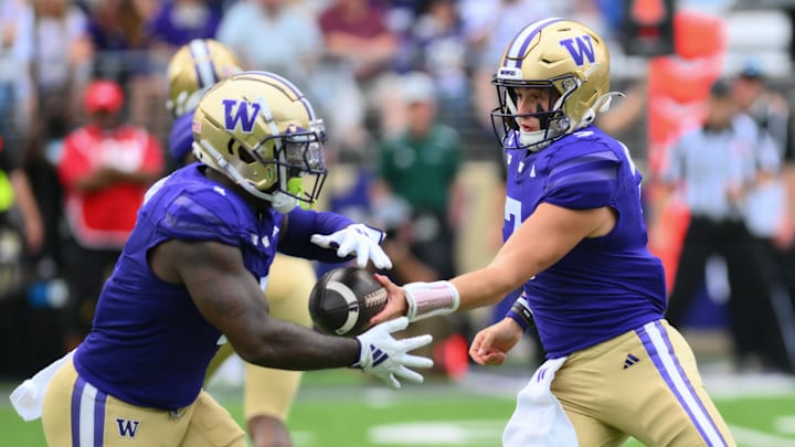 Sep 7, 2024; Seattle, Washington, USA; Washington Huskies quarterback Will Rogers (7) hands the ball off to running back Jonah Coleman (1) during the first half against the Eastern Michigan Eagles at Alaska Airlines Field at Husky Stadium. Mandatory Credit: Steven Bisig-Imagn Images