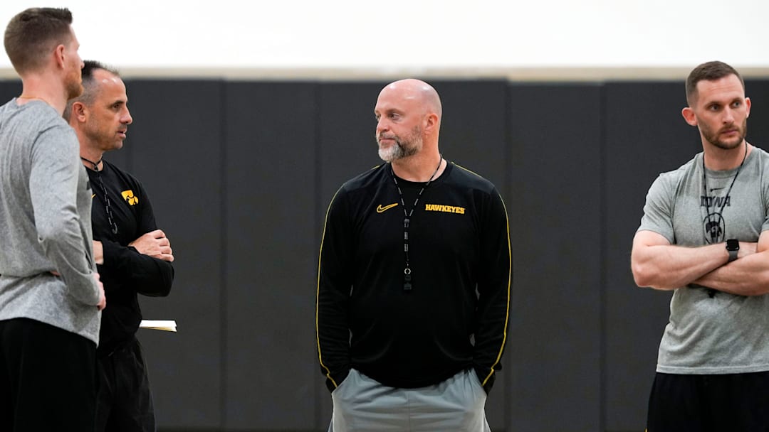 Iowa men’s basketball coach Luke Barnwell, Ben McCollum, Josh Sash and Connor Wheeler talk after practice June 19, 2025 at Carver-Hawkeye Arena in Iowa City, Iowa.
