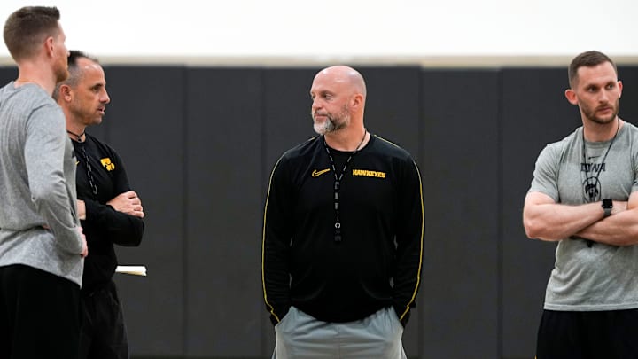 Iowa men’s basketball coach Luke Barnwell, Ben McCollum, Josh Sash and Connor Wheeler talk after practice June 19, 2025 at Carver-Hawkeye Arena in Iowa City, Iowa.