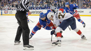 May 24, 2024; New York, New York, USA; New York Rangers center Vincent Trocheck (16) faces off against Florida Panthers center Eetu Luostarinen (27) during overtime in game two of the Eastern Conference Final of the 2024 Stanley Cup Playoffs at Madison Square Garden. Mandatory Credit: Vincent Carchietta-USA TODAY Sports