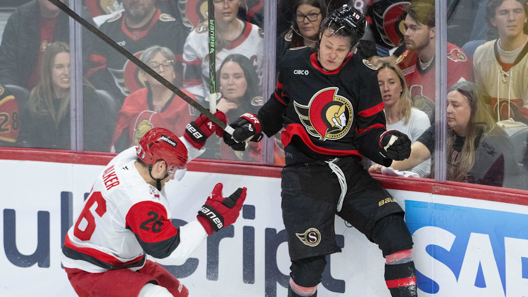 Apr 25, 2026; Ottawa, Ontario, CAN; Carolina Hurricanes defenseman Sean Walker (26) and  Ottawa Senators center Tim Stutzle (18) battle for the puck in the third period of game four of the first round of the 2026 Stanley Cup Playoffs at the Canadian Tire Centre. Mandatory Credit: Marc DesRosiers-Imagn