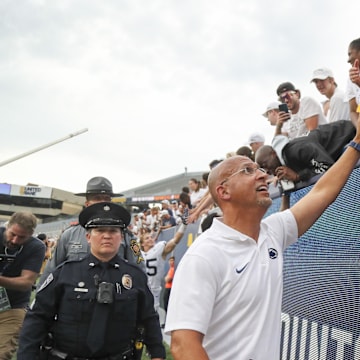 Penn State coach James Franklin celebrates with fans after his team defeated the West Virginia Mountaineers. 