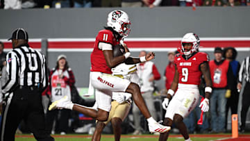 Nov 1, 2025; Raleigh, North Carolina, USA;  North Carolina State Wolfpack quarter back CJ Bailey (11) scores a touchdown against the Georgia Tech Yellow Jackets during the first quarter at Carter-Finley Stadium. Mandatory Credit: Zachary Taft-Imagn Images