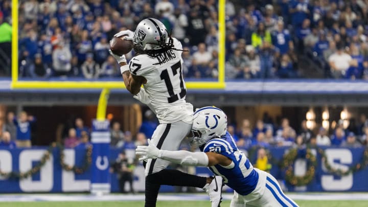 Dec 31, 2023; Indianapolis, Indiana, USA; Las Vegas Raiders wide receiver Davante Adams (17) catches the ball while Indianapolis Colts safety Nick Cross (20) defends  in the first quarter at Lucas Oil Stadium. Mandatory Credit: Trevor Ruszkowski-USA TODAY Sports