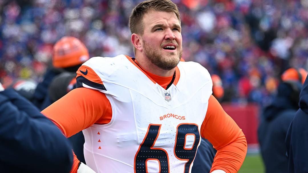 Jan 12, 2025; Orchard Park, New York, USA; Denver Broncos offensive tackle Mike McGlinchey (69) on the sidelines before an AFC wild card game against the Buffalo Bills at Highmark Stadium. Mandatory Credit: Mark Konezny-Imagn Images