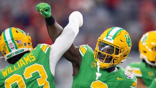 Jan 1, 2024; Glendale, AZ, USA; Oregon Ducks linebacker Jeffrey Bassa (2) with defensive back Evan Williams (33) against the 