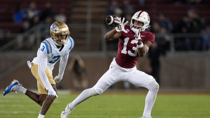 Oct 21, 2023; Stanford, California, USA; Stanford Cardinal wide receiver Elic Ayomanor (13) catches a pass against UCLA Bruins defensive back Devin Kirkwood (3) during the fourth quarter at Stanford Stadium. Mandatory Credit: Darren Yamashita-USA TODAY Sports