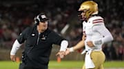 Sep 13, 2025; Stanford, California, USA; Boston College Eagles head coach Bill O'Brien (left) congratulates quarterback Dylan Lonergan (right) during the second quarter against the Stanford Cardinal at Stanford Stadium. Mandatory Credit: Darren Yamashita-Imagn Images