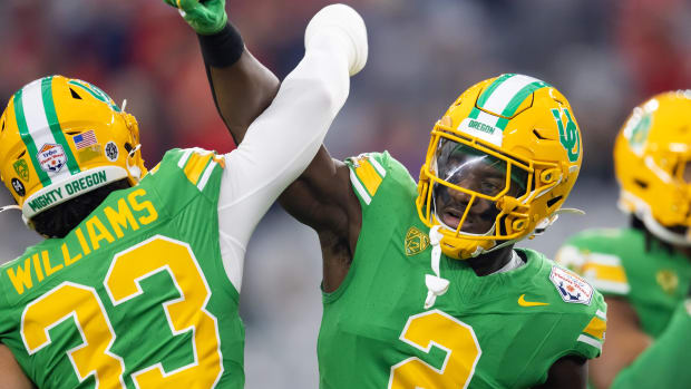 Jan 1, 2024; Glendale, AZ, USA; Oregon Ducks linebacker Jeffrey Bassa (2) with defensive back Evan Williams (33) against the 