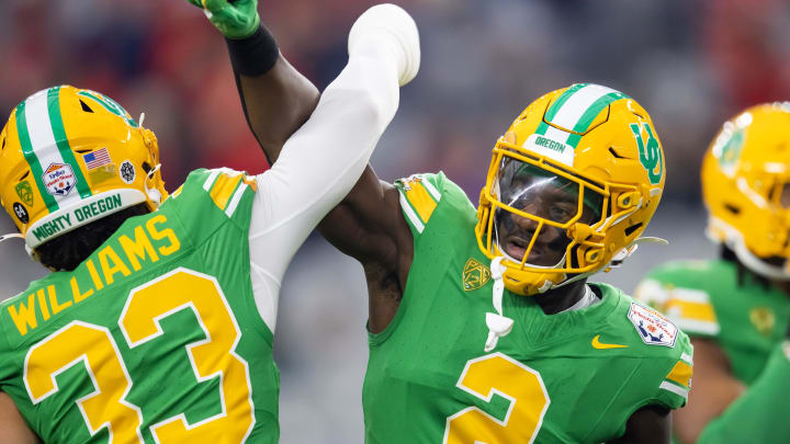 Jan 1, 2024; Glendale, AZ, USA; Oregon Ducks linebacker Jeffrey Bassa (2) with defensive back Evan Williams (33) against the Liberty Flames during the 2024 Fiesta Bowl at State Farm Stadium. 