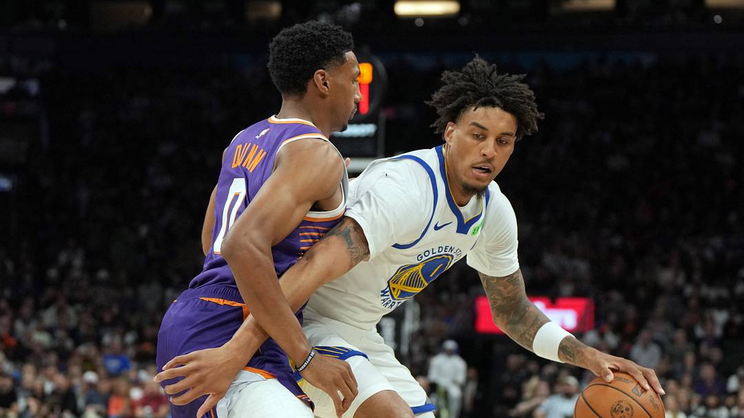 Oct 24, 2026; Phoenix, Arizona, USA;  Golden State Warriors forward Yaxel Lendeborg (1) shields the ball from Phoenix Suns forward Ryan Dunn (0) in the first half at Mortgage Matchup Center.  Mandatory Credit: Rick Scuteri-Imagn Images