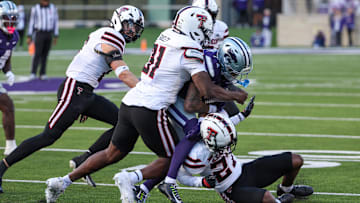 Kansas State Wildcats wide receiver Jayce Brown (1) is tackled by Texas Tech Red Raiders defensive back Amier Boyd (27) and linebacker David Bailey (31) during the third quarter at Bill Snyder Family Football Stadium.