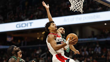 Oct 24, 2024; Washington, District of Columbia, USA; Washington Wizards guard Jordan Poole (13) drives to the basket as Boston Celtics guard Derrick White (9) defends in the second half at Capital One Arena. Mandatory Credit: Geoff Burke-Imagn Images