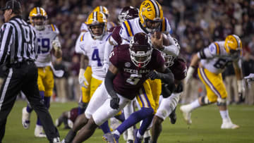 Nov 26, 2022; College Station, Texas, USA; LSU Tigers quarterback Jayden Daniels (5) and Texas A&M Aggies defensive lineman Enai White (6) in action during the game between the Texas A&M Aggies and the LSU Tigers at Kyle Field. Mandatory Credit: Jerome Miron-USA TODAY Sports