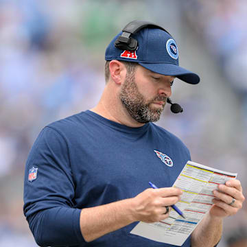 Sep 15, 2024; Nashville, Tennessee, USA;  Tennessee Titans head coach Brian Callahan looks at his play sheet against the New York Jets during the first half at Nissan Stadium. Mandatory Credit: Steve Roberts-Imagn Images