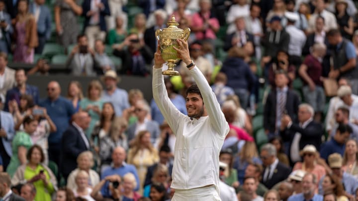 Jul 16, 2023; London, United Kingdom; Carlos Alcaraz (ESP) poses with the trophy after winning  the men   s singles final against Novak Djokovic (SRB) on day 14 at  the All England Lawn Tennis and Croquet Club. 
