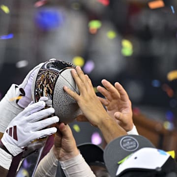 Dec 7, 2024; Arlington, TX, USA; The Arizona State Sun Devils team celebrate with the trophy after the Sun Devils defeat the Iowa State Cyclones and win the 2024 Big 12 Championship at AT&T Stadium. Mandatory Credit: Jerome Miron-Imagn Images