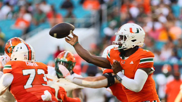 Sep 7, 2024; Miami Gardens, Florida, USA; Miami Hurricanes quarterback Cam Ward (1) passes the football against the Florida A&M Rattlers during the first quarter at Hard Rock Stadium. Mandatory Credit: Sam Navarro-Imagn Images