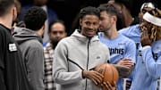 Nov 22, 2025; Dallas, Texas, USA; Memphis Grizzlies guard Ja Morant (12) looks on from the team bench during the second half against the Dallas Mavericks at the American Airlines Center. Mandatory Credit: Jerome Miron-Imagn Images