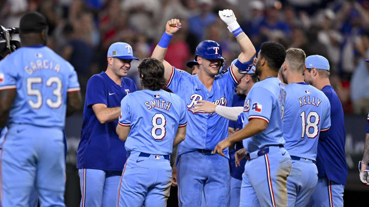 Aug 18, 2024; Arlington, Texas, USA; Texas Rangers left fielder Wyatt Langford (36) and second baseman Marcus Semien (2) and designated hitter Josh Jung (6) and right fielder Adolis Garcia (53) and starting pitcher Nathan Eovaldi (17) and catcher Carson Kelly (18) and third baseman Josh Smith (8) celebrate after the Rangers defeat the Minnesota Twins in extra innings at Globe Life Field. Mandatory Credit: Jerome Miron-USA TODAY Sports