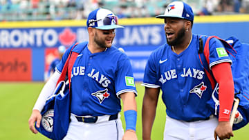 Feb 25, 2025; Dunedin, Florida, USA; Toronto Blue Jays shortstop Bo Bichette (11)  and designated hitter Vladimir Guerrero Jr. (27) walk towards the dugout before a spring training game against the St. Louis Cardinals  at TD Ballpark. Mandatory Credit: Jonathan Dyer-Imagn Images