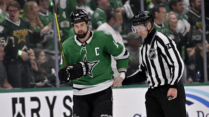 May 13, 2025; Dallas, Texas, USA; Dallas Stars left wing Jamie Benn (14) is led off the ice by linesman Trent Knorr (74) after receiving a roughing penalty against the Winnipeg Jets during the third period in game four of the second round of the 2025 Stanley Cup Playoffs at American Airlines Center. Mandatory Credit: Jerome Miron-Imagn Images