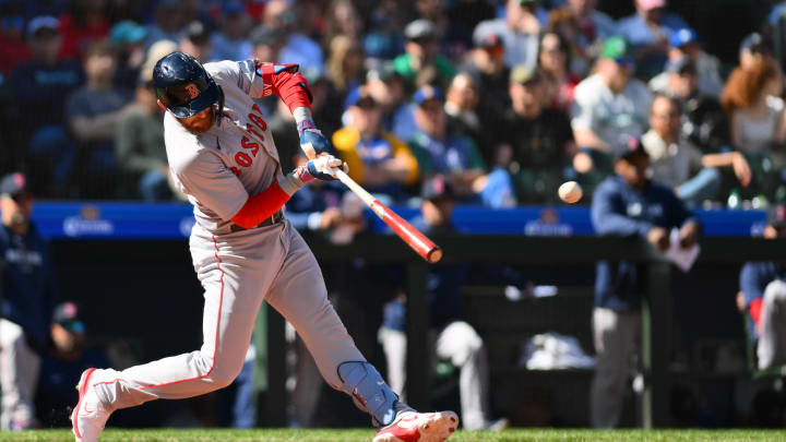 Mar 31, 2024; Seattle, Washington, USA; Boston Red Sox shortstop Trevor Story (10) hits a single against the Seattle Mariners during the seventh inning at T-Mobile Park. Mandatory Credit: Steven Bisig-USA TODAY Sports